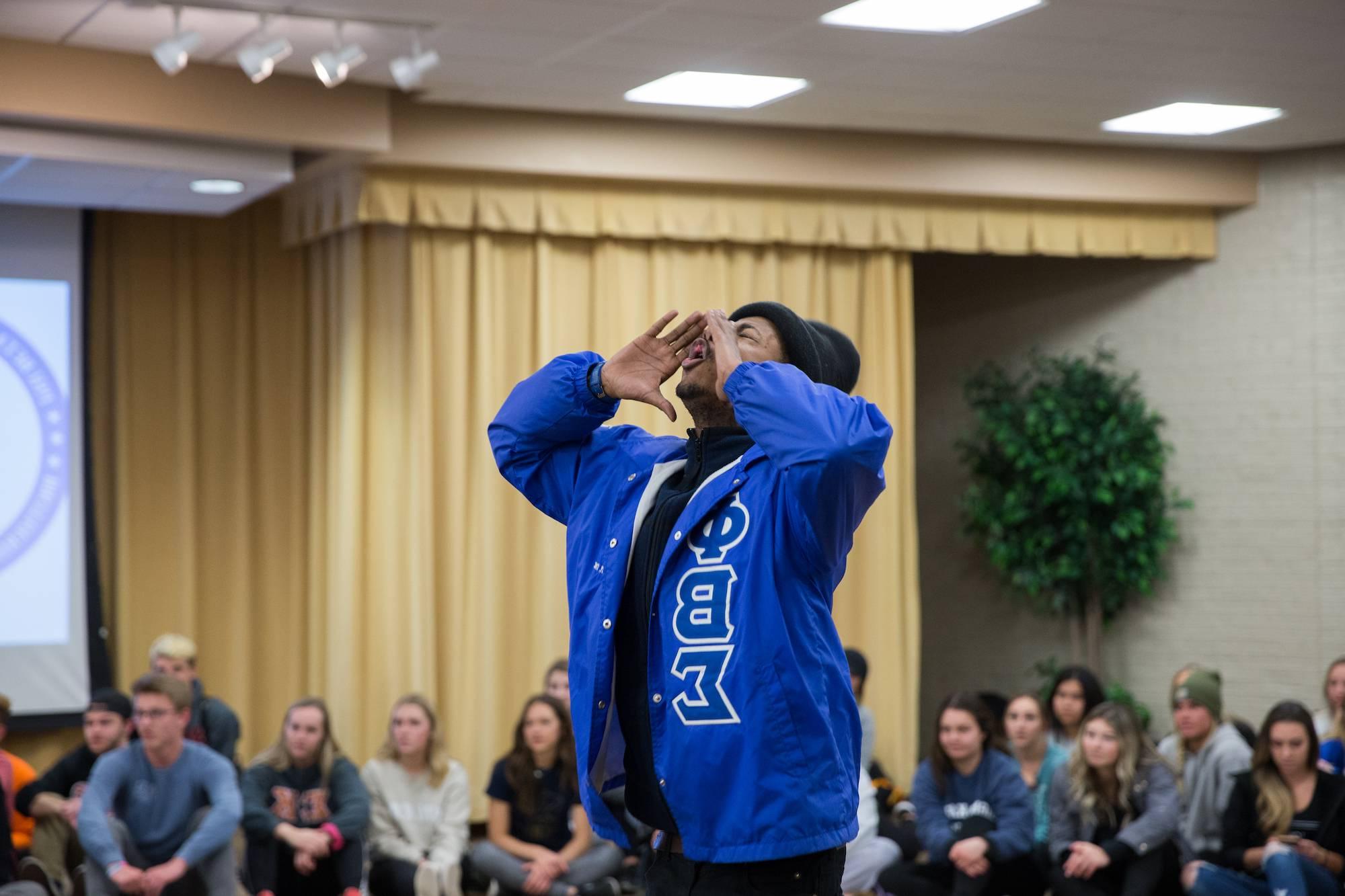 student chanting with their hands around their mouth